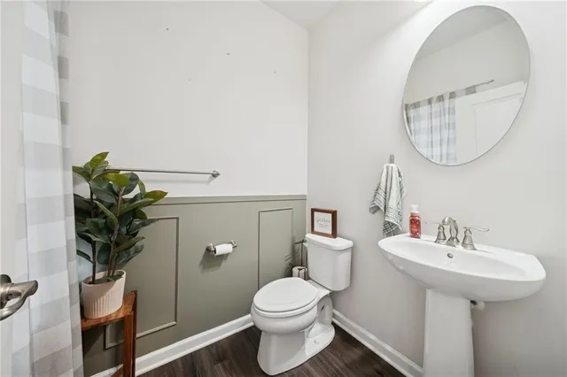 a bathroom with a sink toilet and a mirror