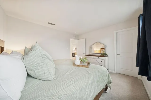 a bedroom with a bed and a lamp