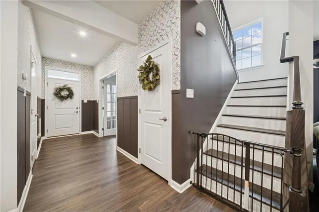 a view of a hallway view with wooden floor and staircase
