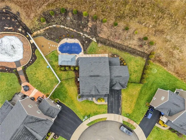 an aerial view of a house with a swimming pool
