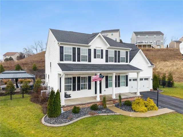 a front view of a house with a yard table and chairs