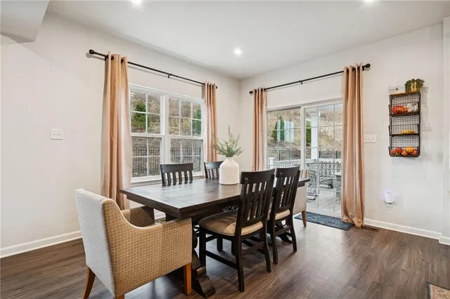 a dining room with furniture and wooden floor