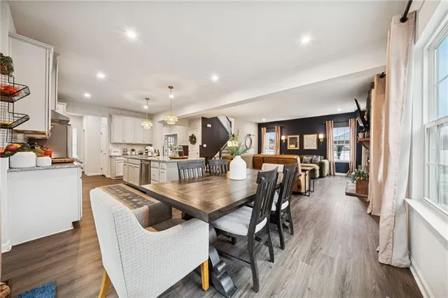a dining room with furniture and wooden floor