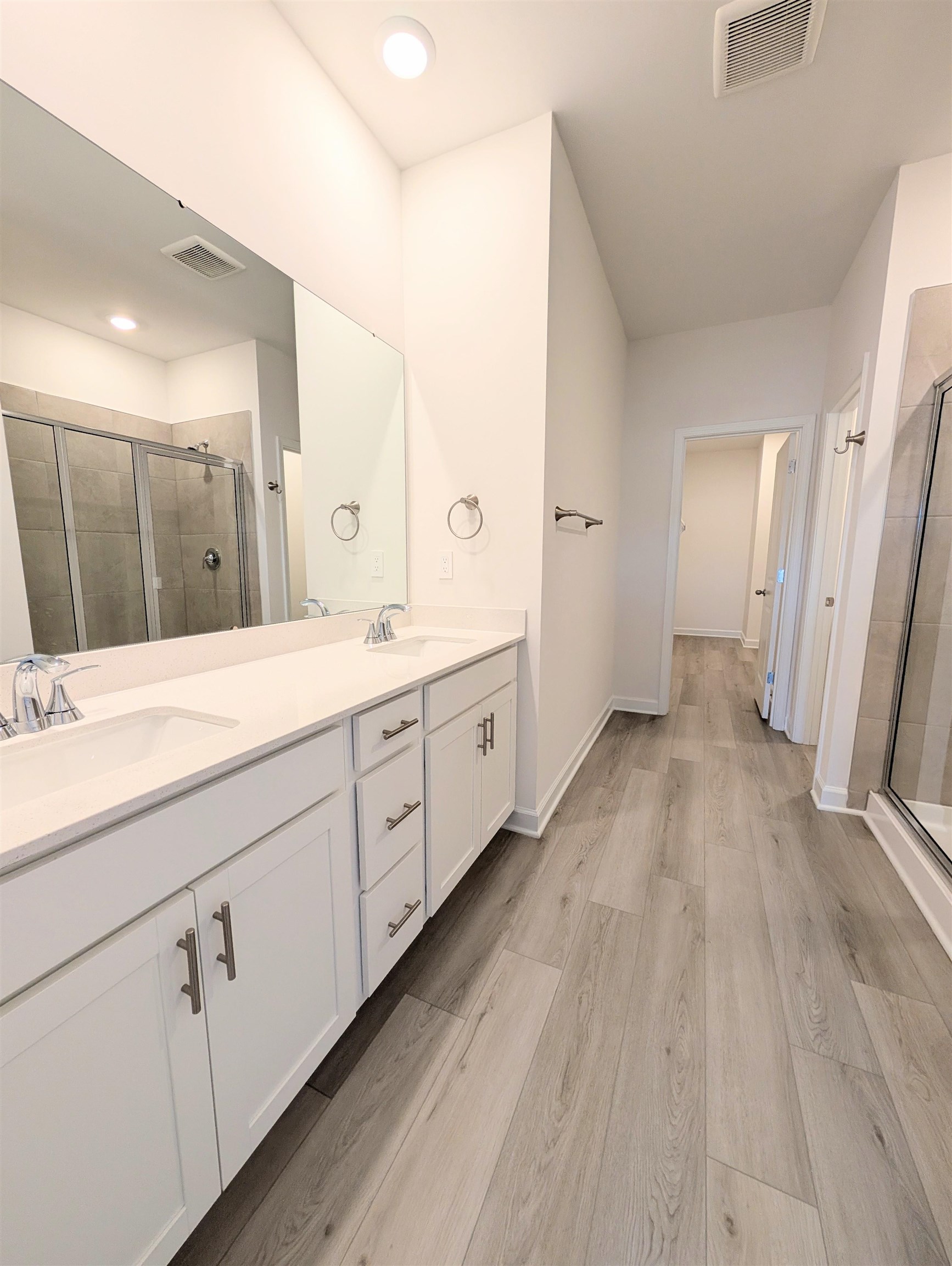 1508 Regal Fern Way Longs, SC 29568 - Photo 17 of 38 Full bath featuring a shower stall, double vanity, and light wood-style floors