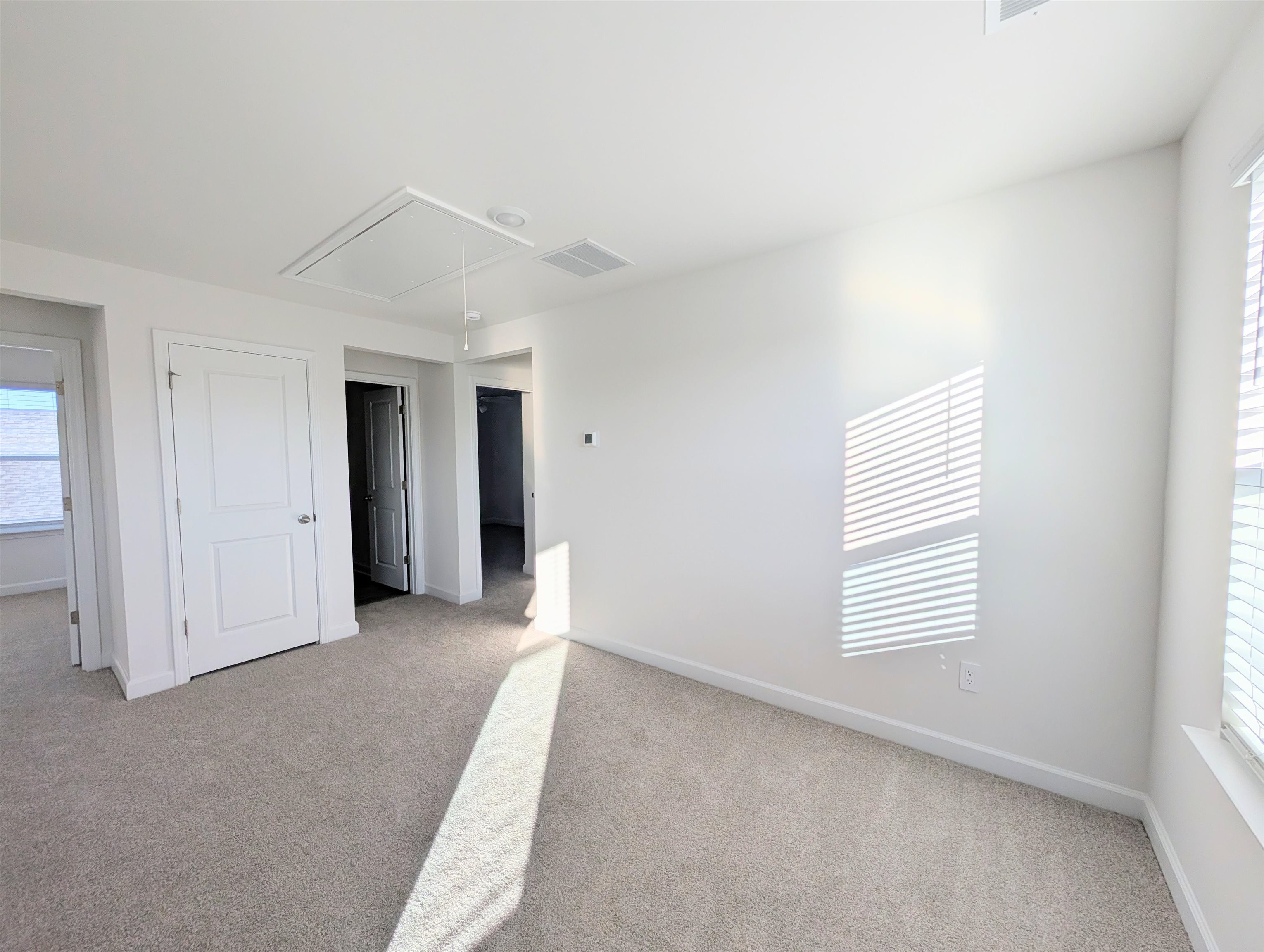 1508 Regal Fern Way Longs, SC 29568 - Photo 23 of 38 Unfurnished bedroom with attic access, light carpet, and a closet