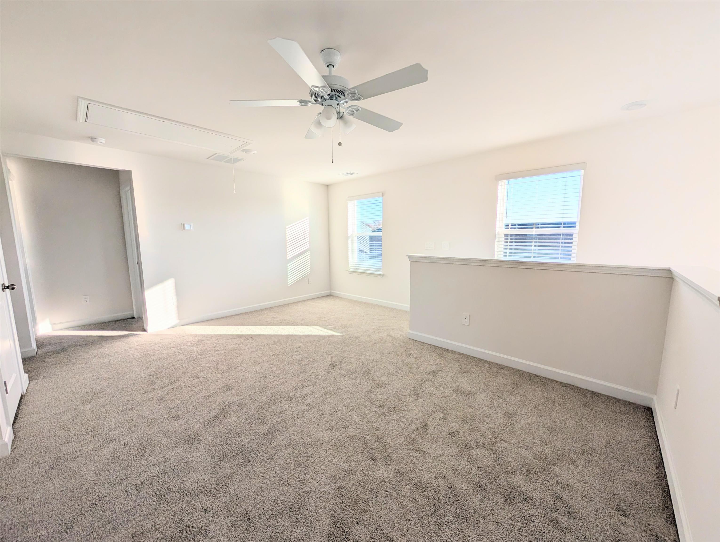1508 Regal Fern Way Longs, SC 29568 - Photo 24 of 38 Spare room with attic access, light colored carpet, and ceiling fan