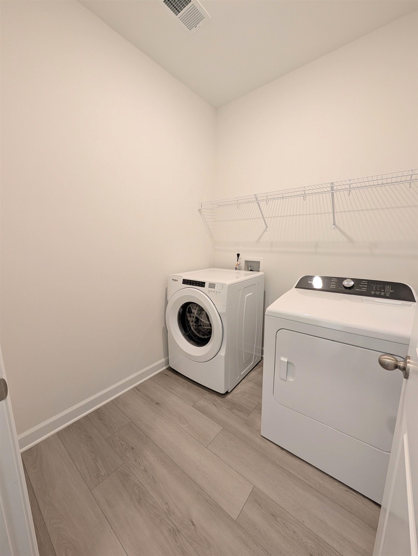 1508 Regal Fern Way Longs, SC 29568 - Photo 33 of 38 Laundry room with light wood-type flooring and separate washer and dryer