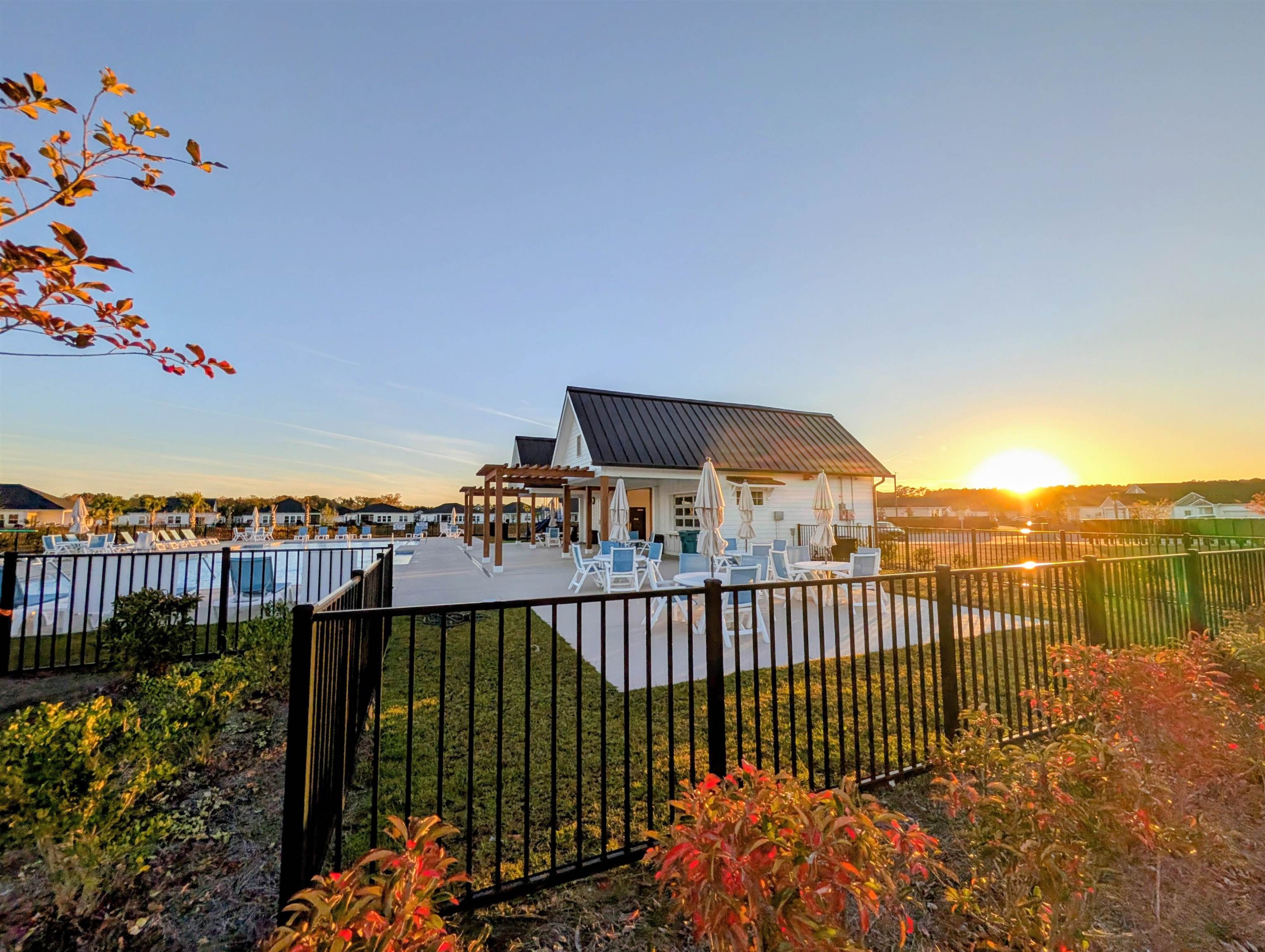 1508 Regal Fern Way Longs, SC 29568 - Photo 36 of 38 Back of house at dusk with a patio, a metal roof, a fenced backyard, and a pergola