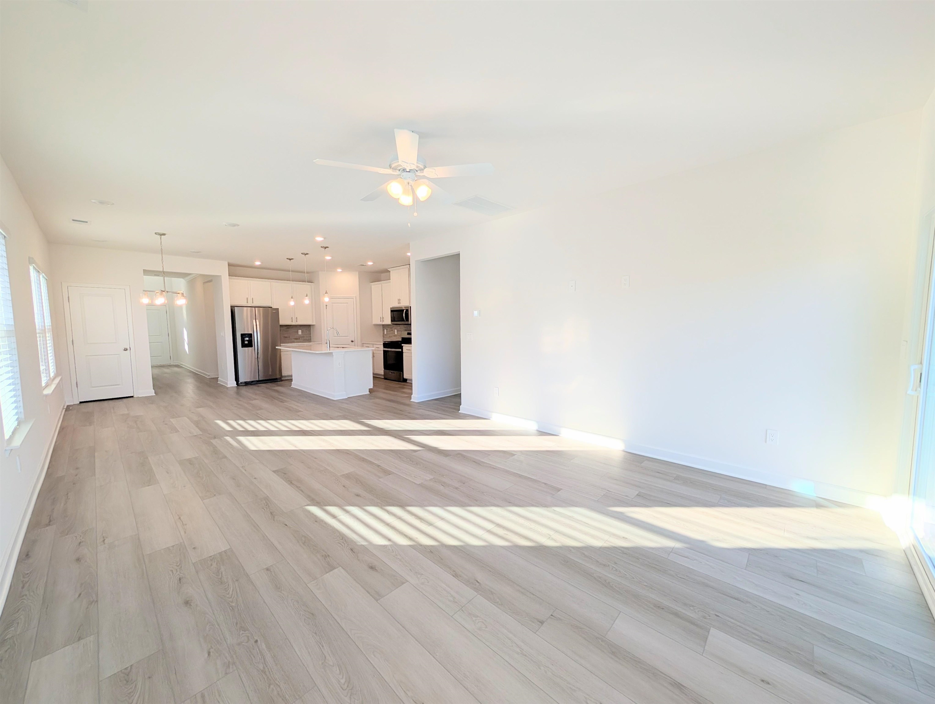 1508 Regal Fern Way Longs, SC 29568 - Photo 9 of 38 Unfurnished living room with light wood-type flooring, recessed lighting, a chandelier, and a ceiling fan