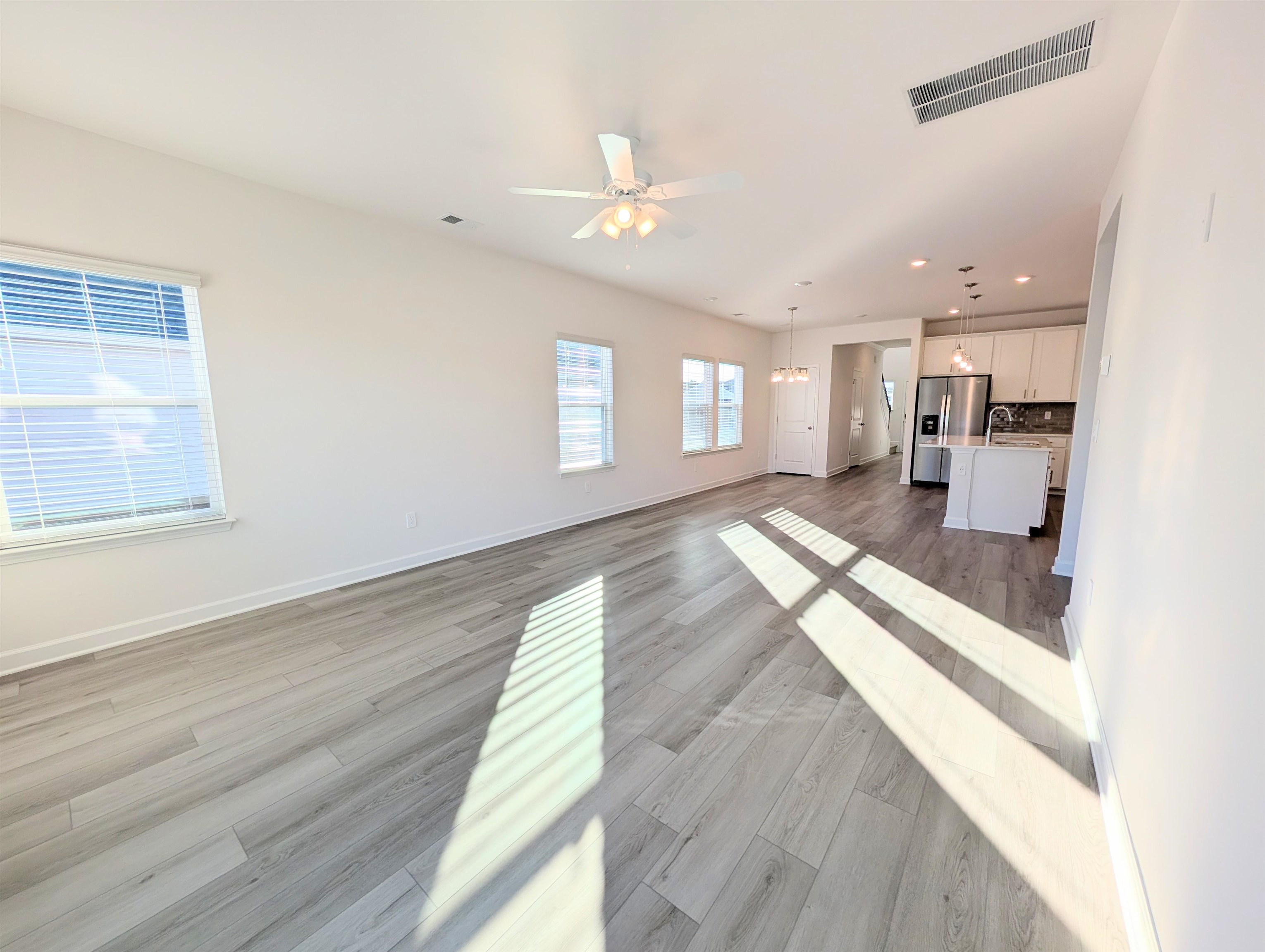 1508 Regal Fern Way Longs, SC 29568 - Photo 10 of 38 Unfurnished living room with light wood-style flooring, a ceiling fan, and recessed lighting