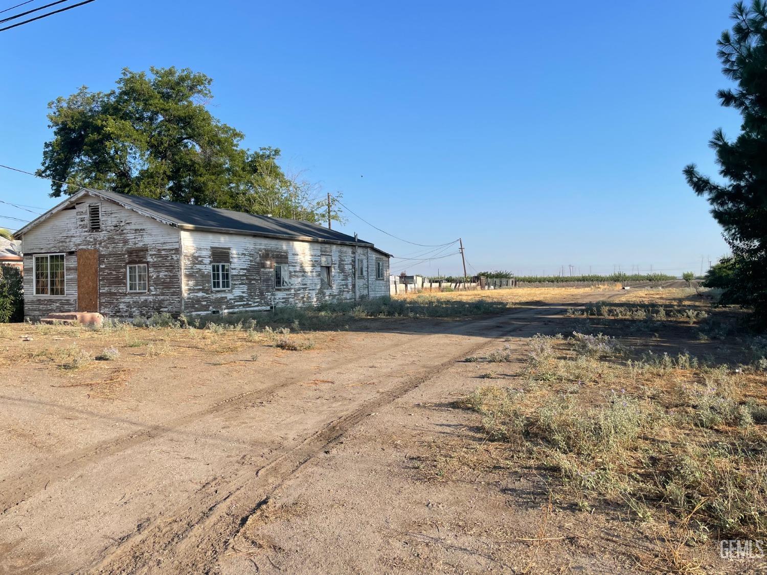 Undisclosed Address Buttonwillow, CA 93206 - Photo 2 of 7 a front view of a house with a yard