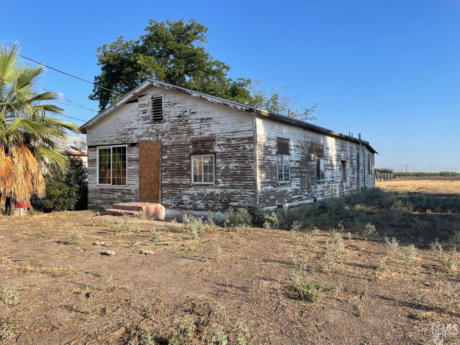 Undisclosed Address Buttonwillow, CA 93206 - Photo 3 of 7 a backyard of a house with large trees