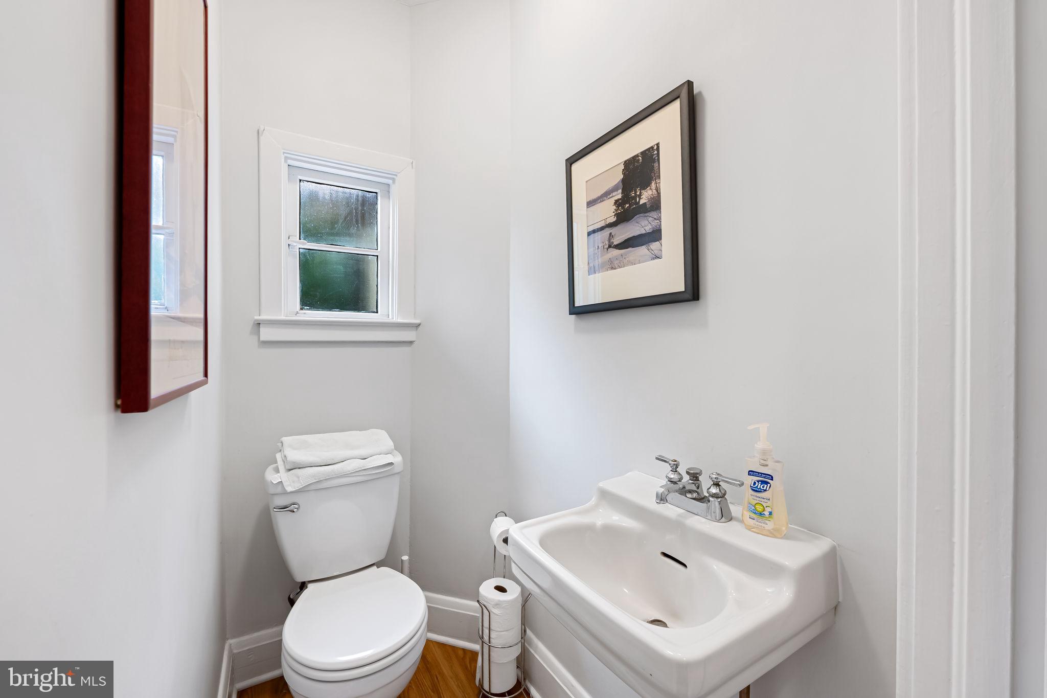 305 Tunbridge Road Baltimore, MD 21212 - Photo 12 of 58 a white toilet sitting next to a bathroom sink
