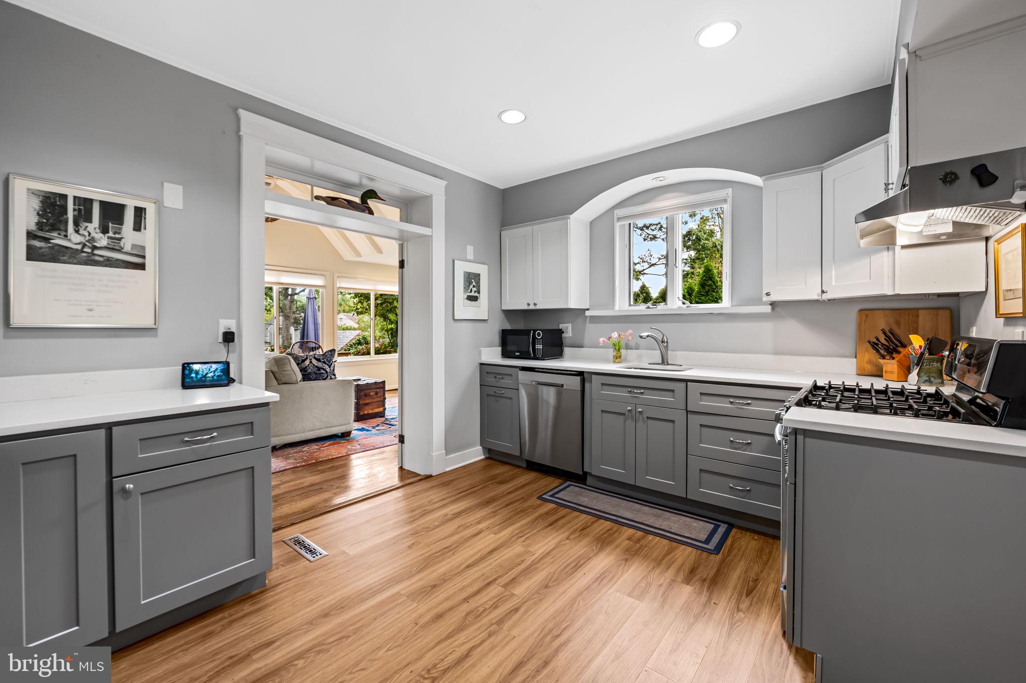 305 Tunbridge Road Baltimore, MD 21212 - Photo 15 of 58 a kitchen with stainless steel appliances granite countertop wooden cabinets a sink a stove a refrigerator and island with wooden floor