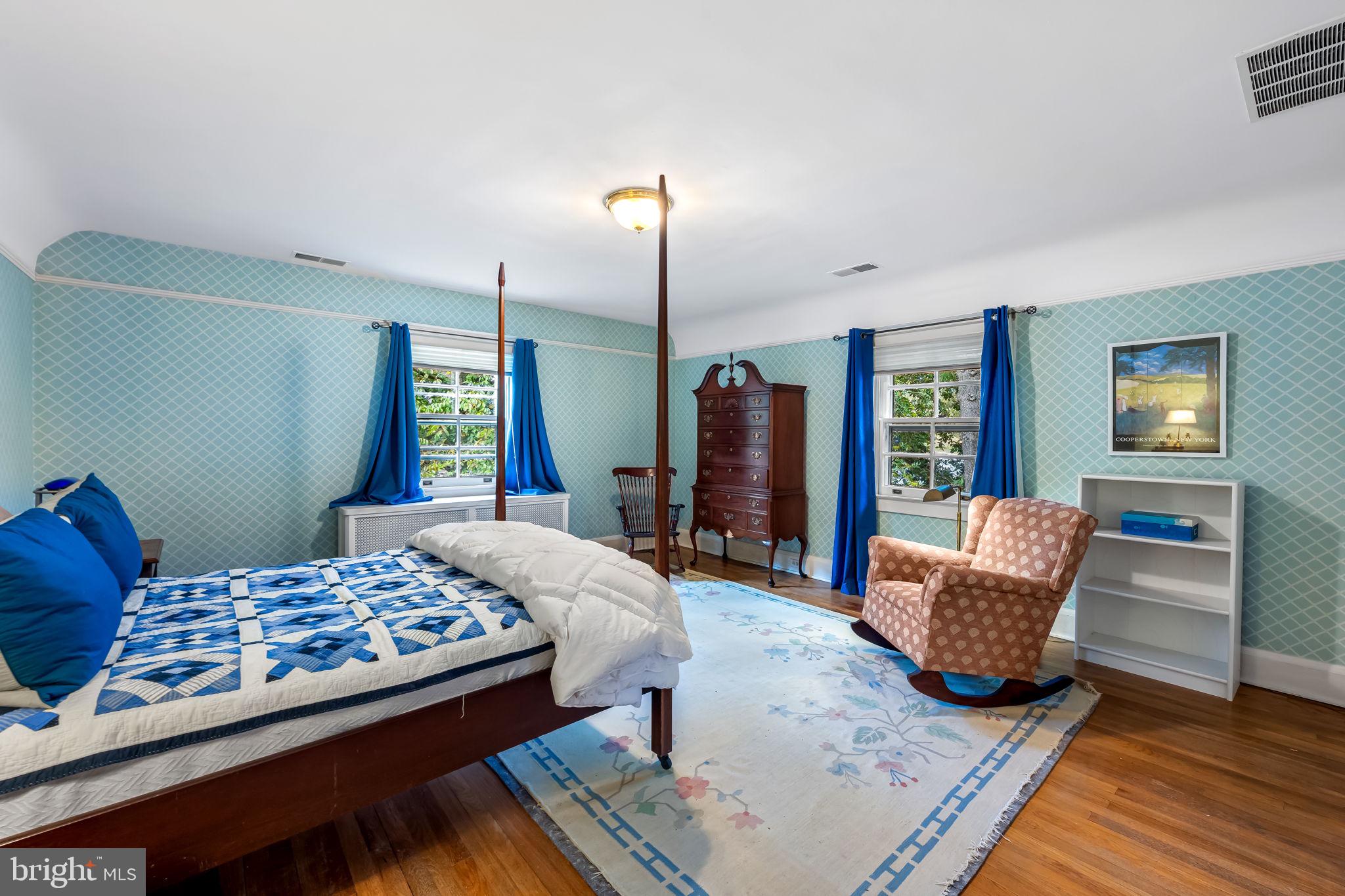 305 Tunbridge Road Baltimore, MD 21212 - Photo 35 of 58 a bedroom with a bed and wooden floor