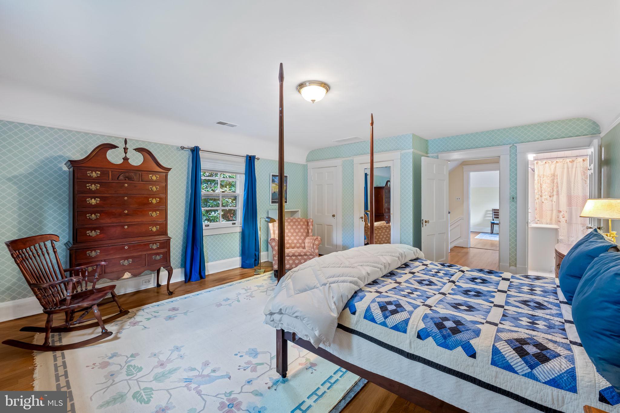 305 Tunbridge Road Baltimore, MD 21212 - Photo 36 of 58 a bedroom with a large bed and a chair