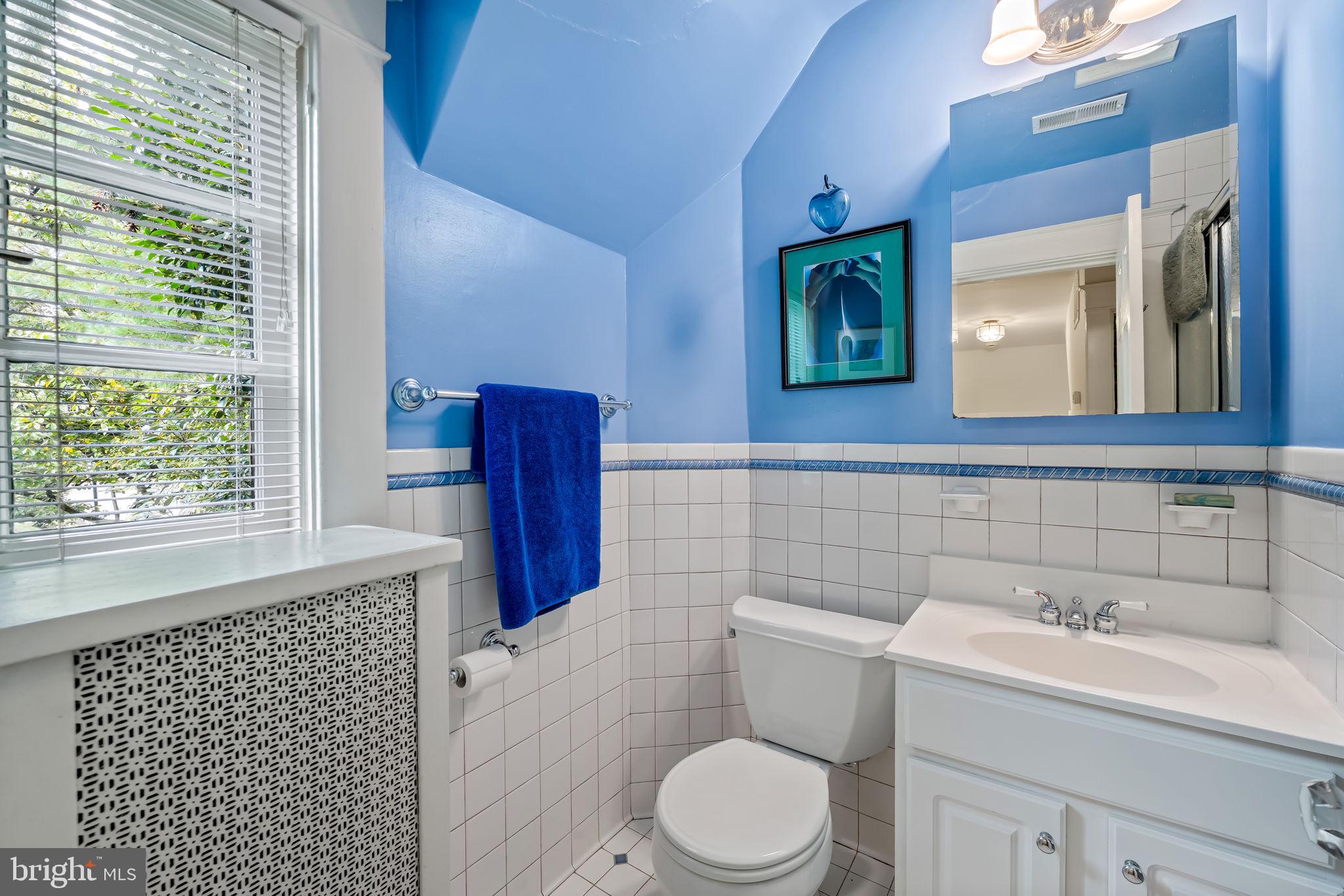 305 Tunbridge Road Baltimore, MD 21212 - Photo 37 of 58 a bathroom with a toilet sink and mirror