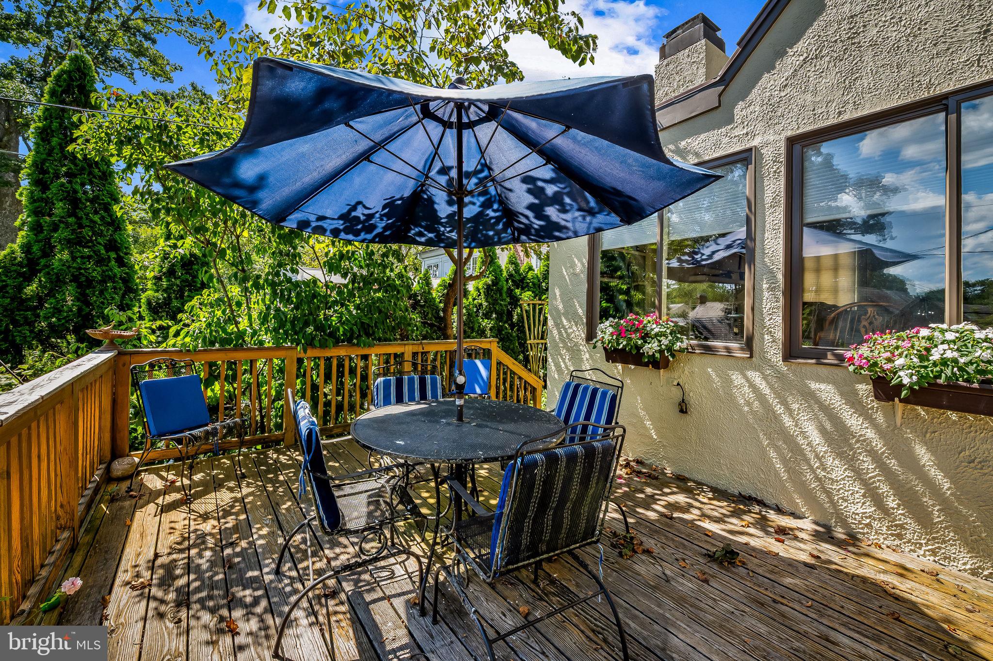 305 Tunbridge Road Baltimore, MD 21212 - Photo 49 of 58 a patio with wooden floor a yard a table and chairs