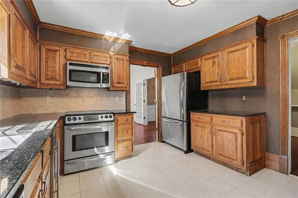 a kitchen with stainless steel appliances granite countertop a refrigerator stove and microwave