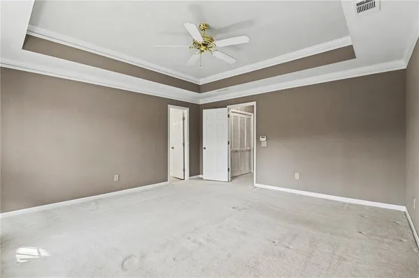 a view of an empty room with a ceiling fan