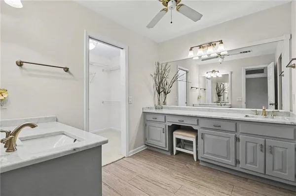 a spacious bathroom with a granite countertop sink a mirror and a