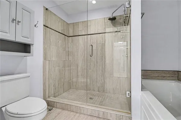 a bathroom with a shower a toilet and a shower