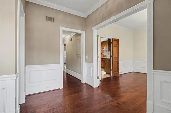 an empty room with wooden floor & closet