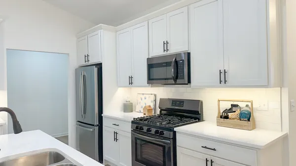 a kitchen with stainless steel appliances a stove microwave and refrigerator