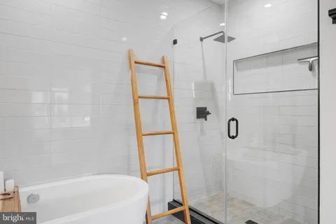 a bathroom with a shower and a bath tub