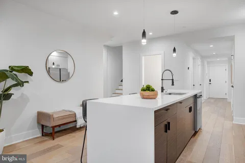 a kitchen with a sink a counter space and a window
