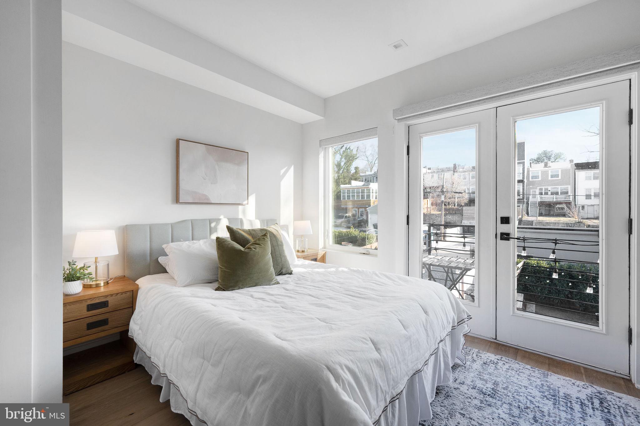320 Webster Street Northwest, Unit 2 Washington, DC 20011 - Photo 10 of 25 a bedroom with a large bed and a window