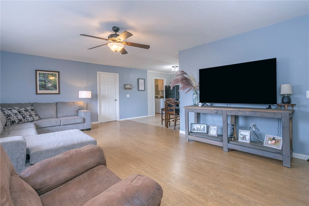 1331 Centerville Road Anderson, SC 29625 - Photo 3 of 35 This inviting living space features warm flooring and a ceiling fan, creating a comfortable atmosphere.