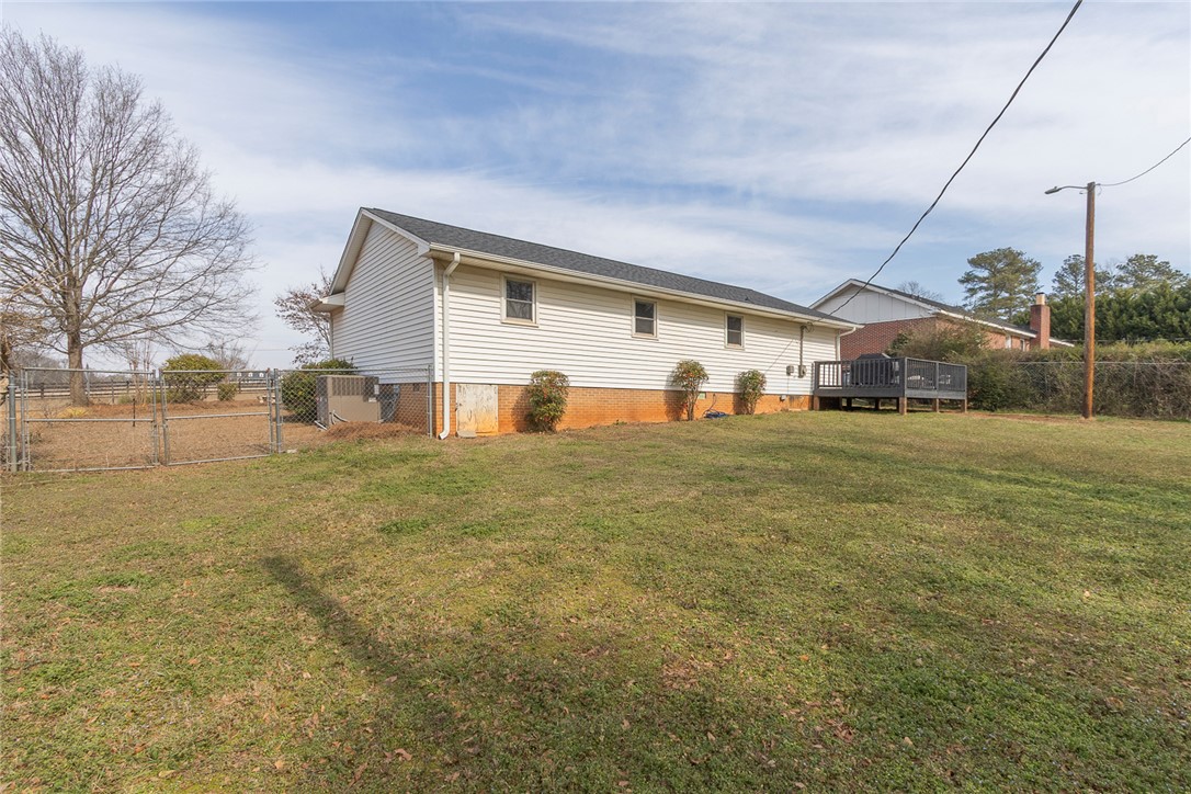 1331 Centerville Road Anderson, SC 29625 - Photo 34 of 35 This spacious backyard features a versatile deck and ample green space, perfect for outdoor activities.