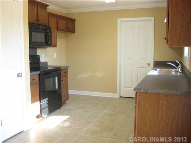 305 Springlake Road York, SC 29745 - Photo 11 of 16 a kitchen with a sink and a stove top oven