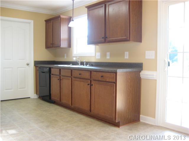 305 Springlake Road York, SC 29745 - Photo 9 of 16 a kitchen with cabinets appliances a sink and a window