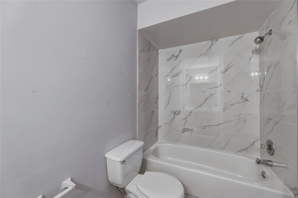 4799 Sisson Road Titusville, FL 32780 - Photo 18 of 23 a bathroom with a toilet and a bathtub