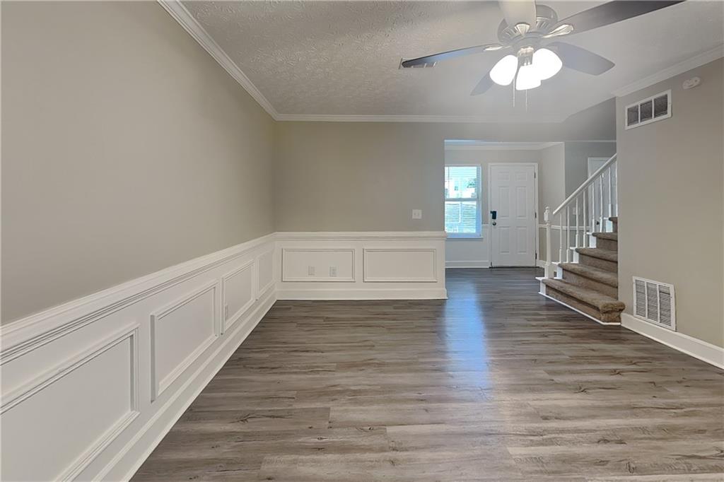 335 Olde Bridge Way Johns Creek, GA 30022 - Photo 2 of 19 a view of an empty room with wooden floor and a ceiling fan