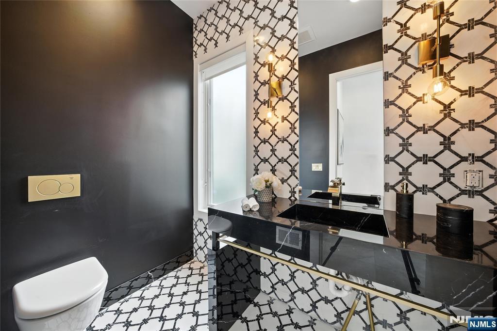 44 Floral Terrace Tenafly, NJ 07670 - Photo 16 of 49 a bathroom with a sink a toilet and shower curtain