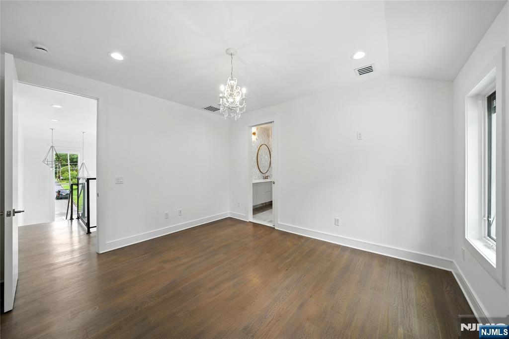 44 Floral Terrace Tenafly, NJ 07670 - Photo 20 of 49 an empty room with wooden floor chandelier and windows