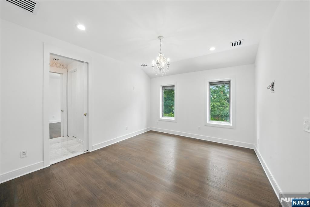 44 Floral Terrace Tenafly, NJ 07670 - Photo 21 of 49 an empty room with wooden floor and windows