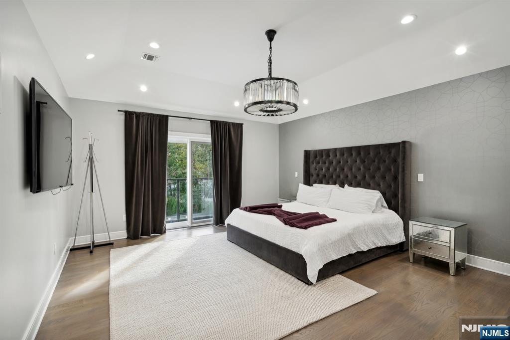 44 Floral Terrace Tenafly, NJ 07670 - Photo 24 of 49 a bedroom with a bed and a chandelier