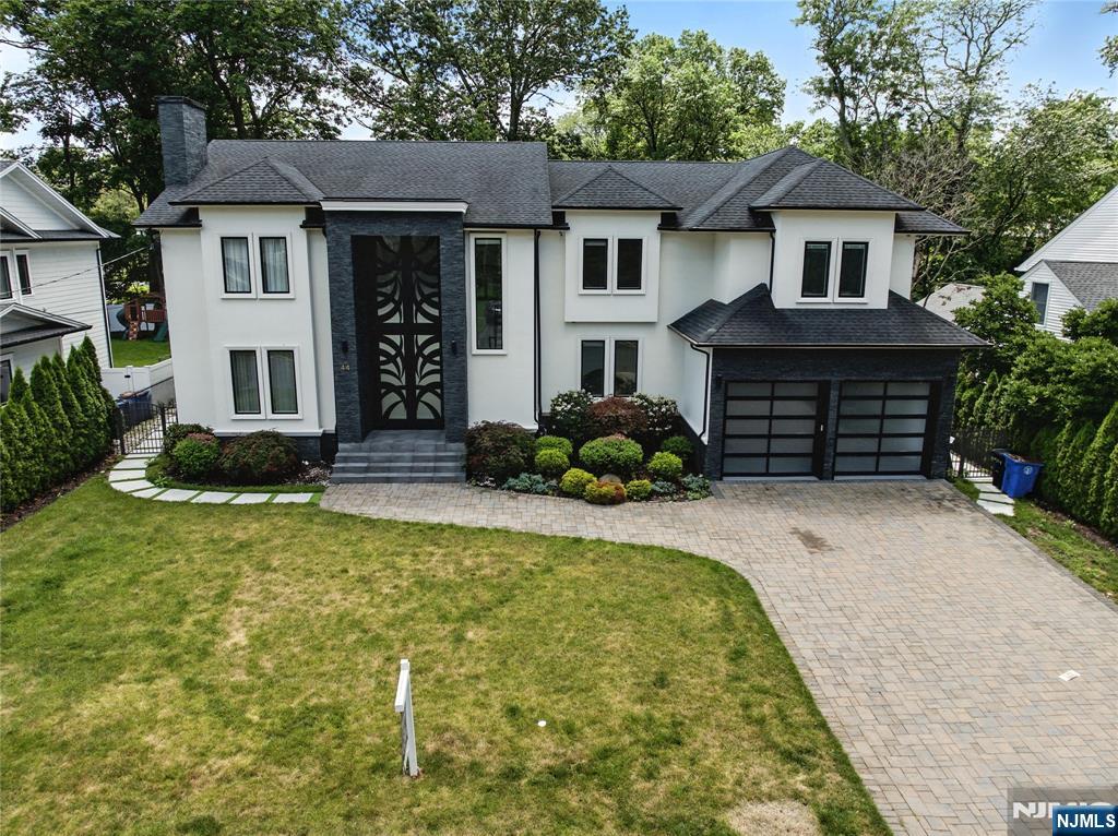44 Floral Terrace Tenafly, NJ 07670 - Photo 46 of 49 a front view of a house with garden
