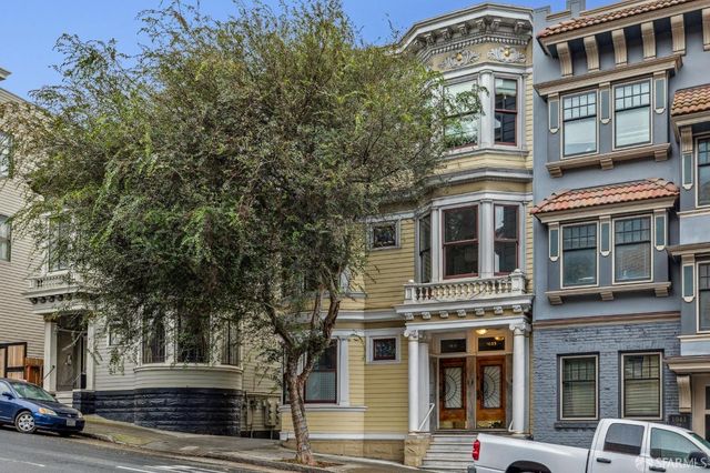 a view of staircase with white walls and a window