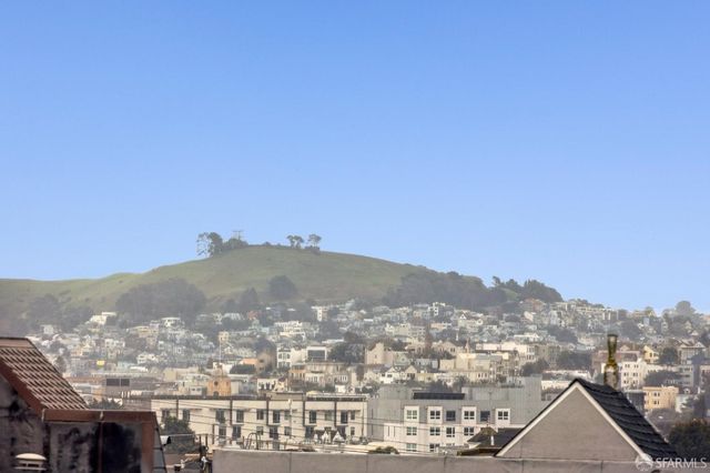 a view of a porch with a door and a refrigerator