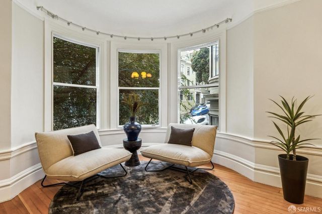 a living room with furniture a table and decor