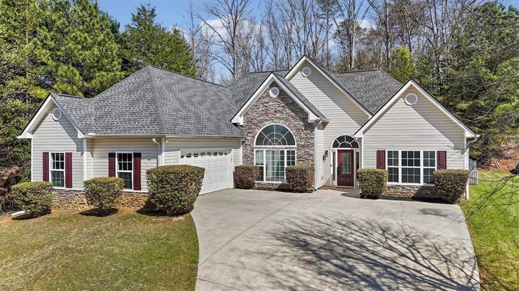a front view of a house with a yard covered in snow