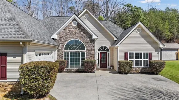 a front view of a house with a yard and garage