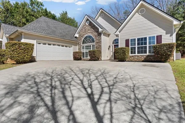 a front view of a house with garden