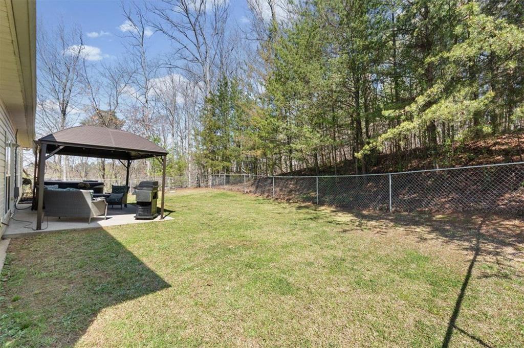 25 Cherokee Hills Drive Rydal, GA 30171 - Photo 46 of 59 a backyard of a house with table and chairs