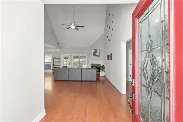 a view of a hallway with wooden floor and furniture
